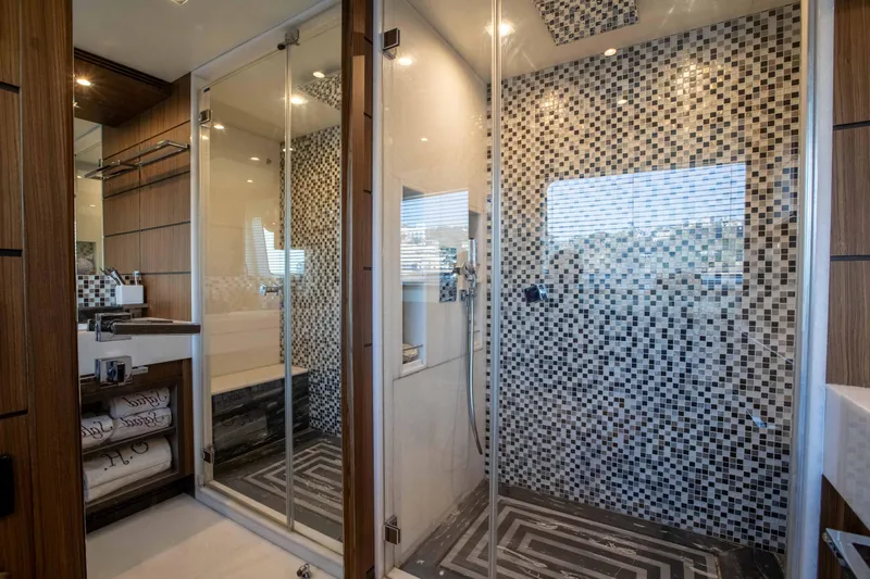 Safad Yacht Photos Pics Luxurious bathroom on a 2015 Benetti 121 yacht with modern glass shower and mosaic tiles.