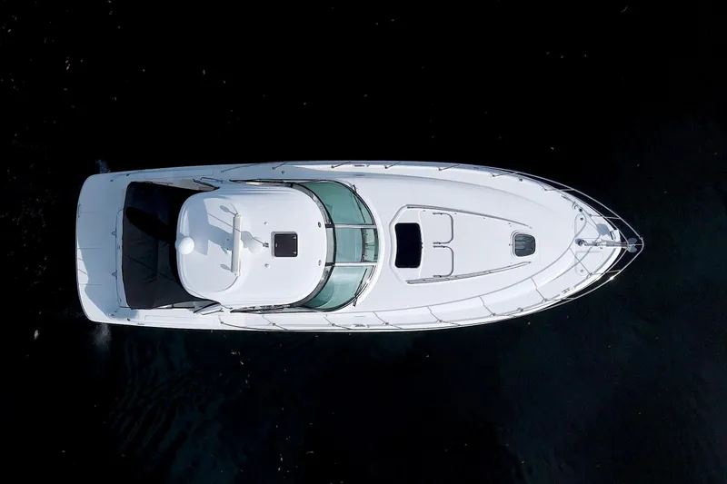  Yacht Photos Pics 2009 Sea Ray 44 Sundancer yacht, aerial view, sleek white design on dark water.