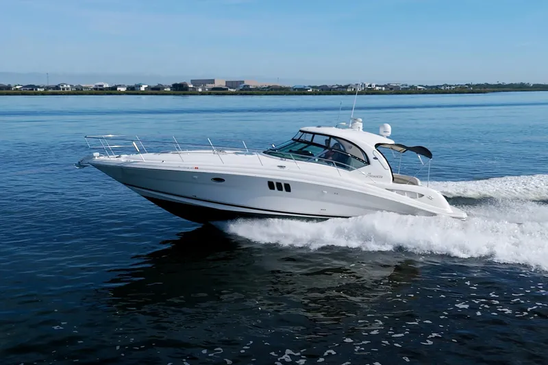  Yacht Photos Pics 2009 Sea Ray 44 Sundancer yacht cruising on calm waters.