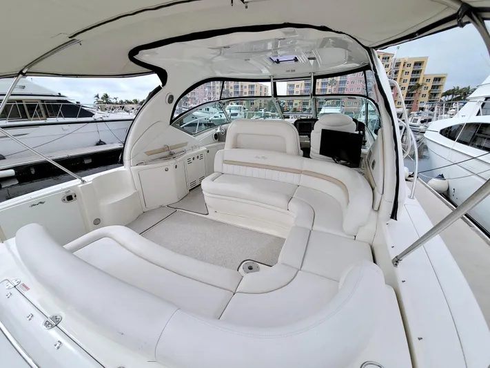  Yacht Photos Pics 2009 Sea Ray 44 Sundancer yacht interior with white seating and marina view.