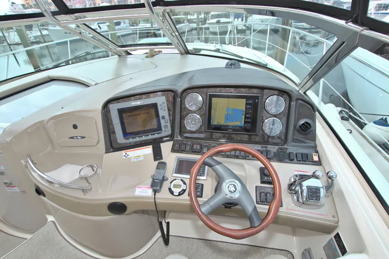  Yacht Photos Pics 2009 Sea Ray 44 Sundancer helm with navigation displays and steering wheel.