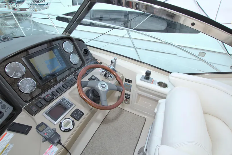  Yacht Photos Pics Helm of 2009 Sea Ray 44 Sundancer with modern navigation controls and plush seating.