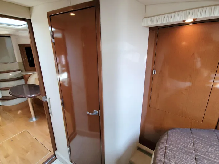  Yacht Photos Pics Interior of 2009 Sea Ray 44 Sundancer yacht, featuring wood paneling and cozy cabin space.