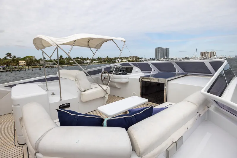  Yacht Photos Pics Luxurious 1999 Azimut 100 Jumbo yacht deck with seating and helm, featuring a canopy.