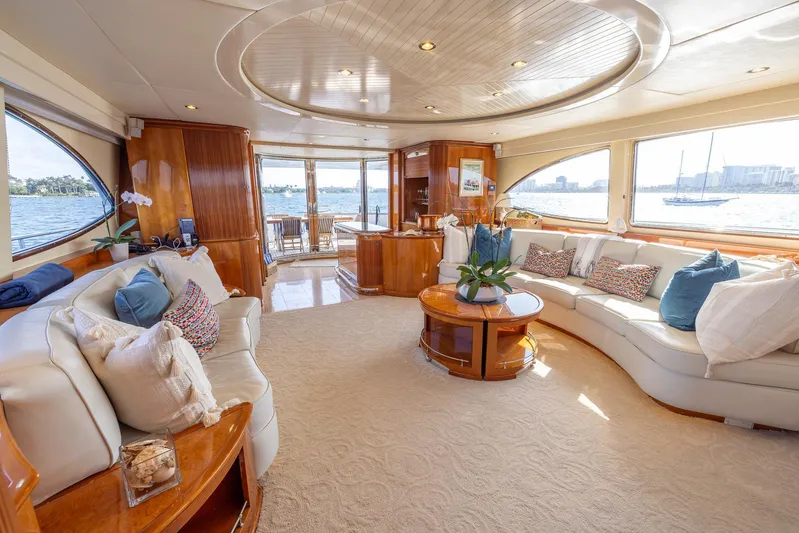  Yacht Photos Pics Luxurious interior of 1999 Azimut 100 Jumbo yacht with elegant seating and panoramic windows.
