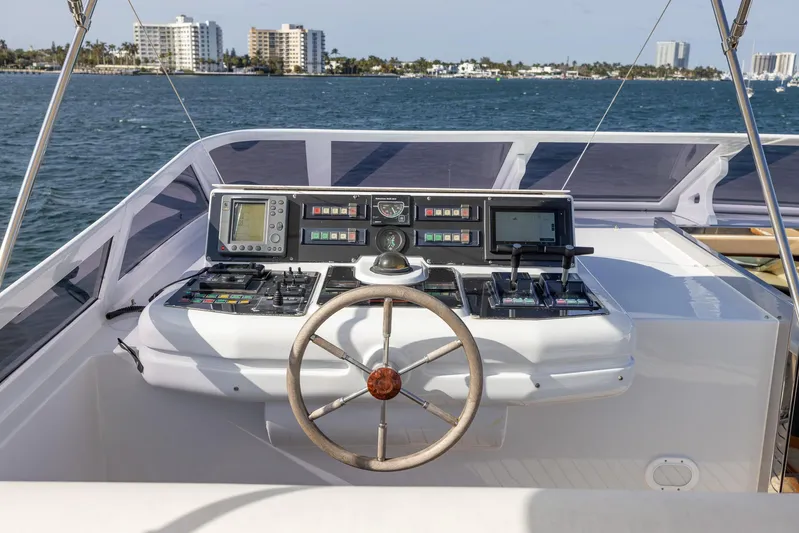  Yacht Photos Pics Helm of 1999 Azimut 100 Jumbo yacht with navigation controls, overlooking ocean and cityscape.