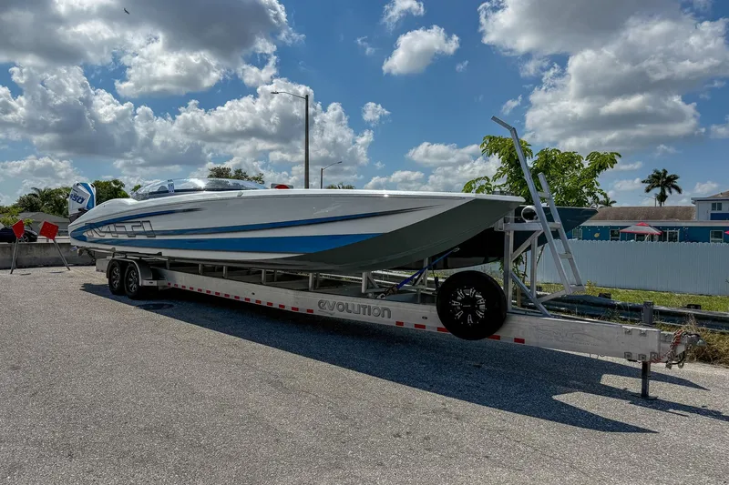 El Gato Yacht Photos Pics 2022 MTI 390X powerboat on trailer under a partly cloudy sky.