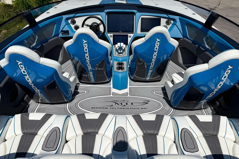 El Gato Yacht Photos Pics Interior of 2022 MTI 390X boat with blue and white seating, advanced dashboard.