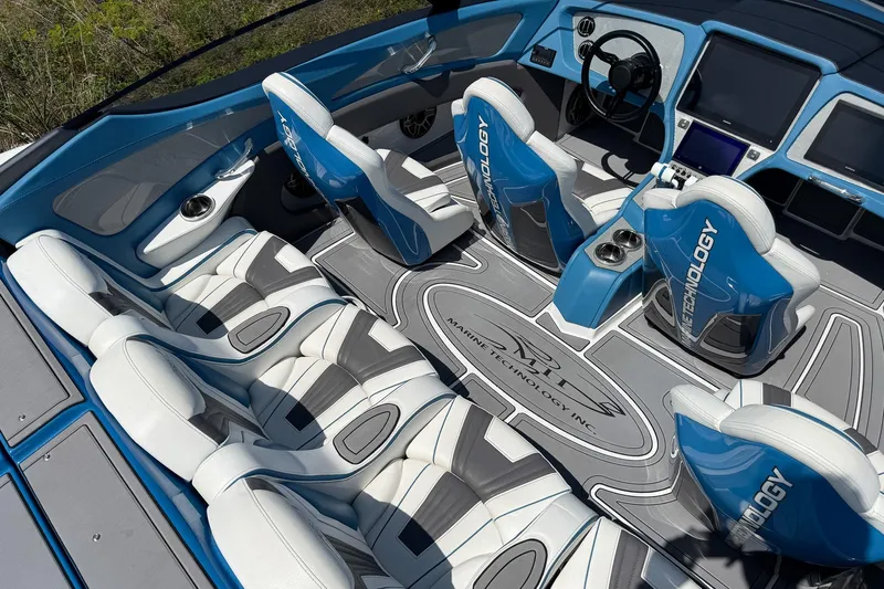 El Gato Yacht Photos Pics Luxurious interior of 2022 MTI 390X boat with blue and white seating.