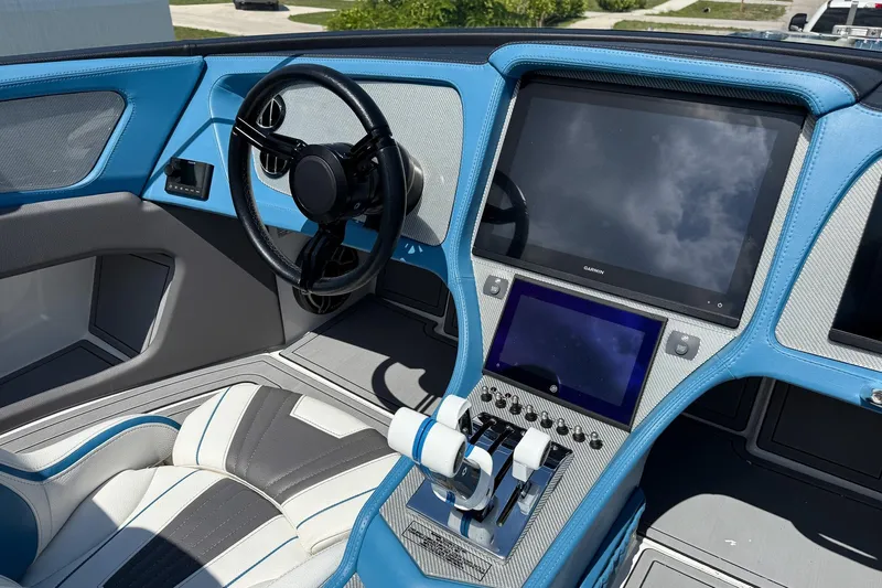 El Gato Yacht Photos Pics Interior of 2022 MTI 390X boat with modern steering and dual screens.