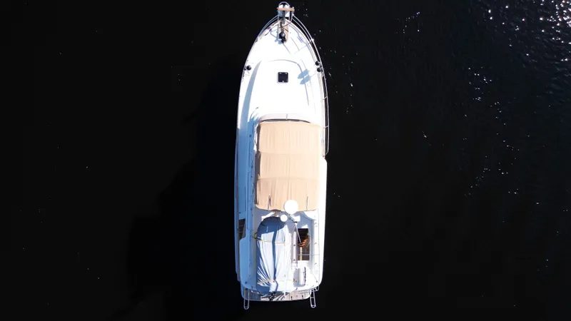 Next Chapter Yacht Photos Pics Aerial view of a 2014 Beneteau Swift Trawler 44 on dark water.