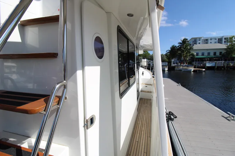 Next Chapter Yacht Photos Pics 2014 Beneteau Swift Trawler 44 docked, showing side deck and stairs.