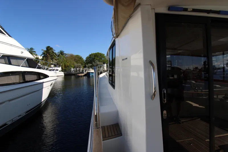 Next Chapter Yacht Photos Pics 2014 Beneteau Swift Trawler 44 docked at a marina, side view.