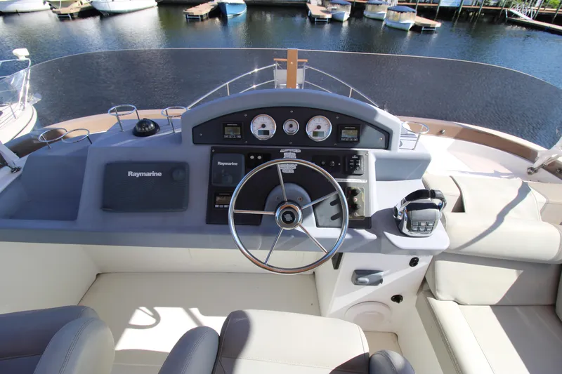 Next Chapter Yacht Photos Pics 2014 Beneteau Swift Trawler 44 helm station with navigation equipment and steering wheel.