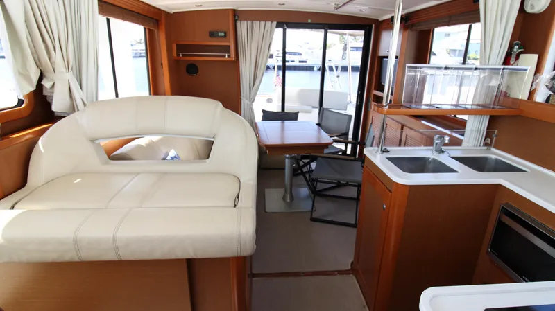 Next Chapter Yacht Photos Pics Interior of 2014 Beneteau Swift Trawler 44 with kitchen, dining area, and seating.