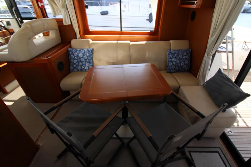 Next Chapter Yacht Photos Pics Interior of 2014 Beneteau Swift Trawler 44 with dining area and seating.