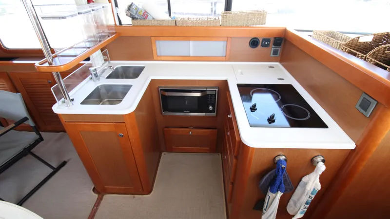 Next Chapter Yacht Photos Pics 2014 Beneteau Swift Trawler 44 kitchen with dual sinks, microwave, and electric stove.