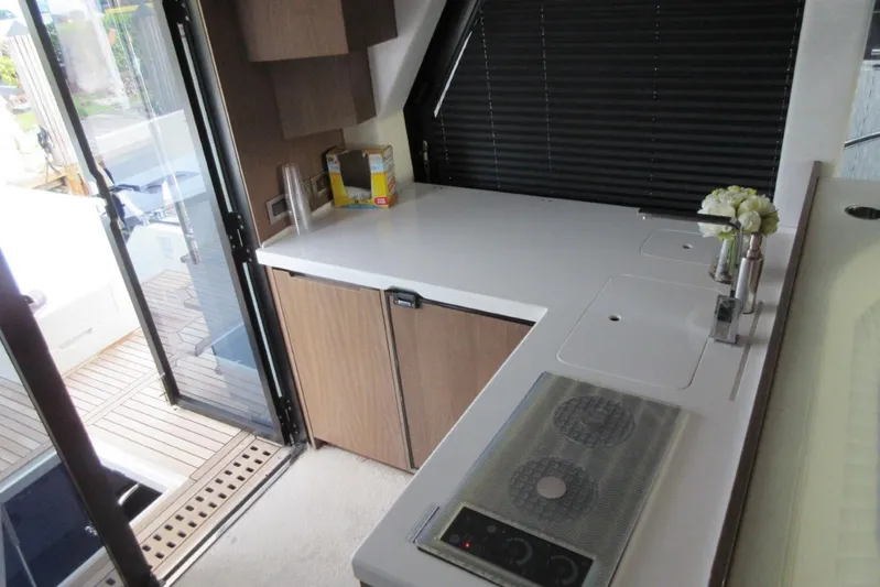  Yacht Photos Pics Modern kitchen interior of 2019 Galeon 470 Sky yacht with sleek countertops and appliances.