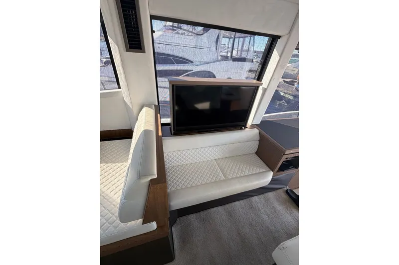  Yacht Photos Pics Interior of 2019 Galeon 470 Sky yacht with white seating and a TV.