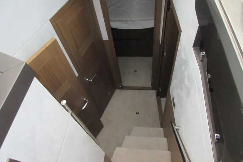  Yacht Photos Pics Interior view of 2019 Galeon 470 Sky yacht, featuring wooden doors and carpeted stairs.
