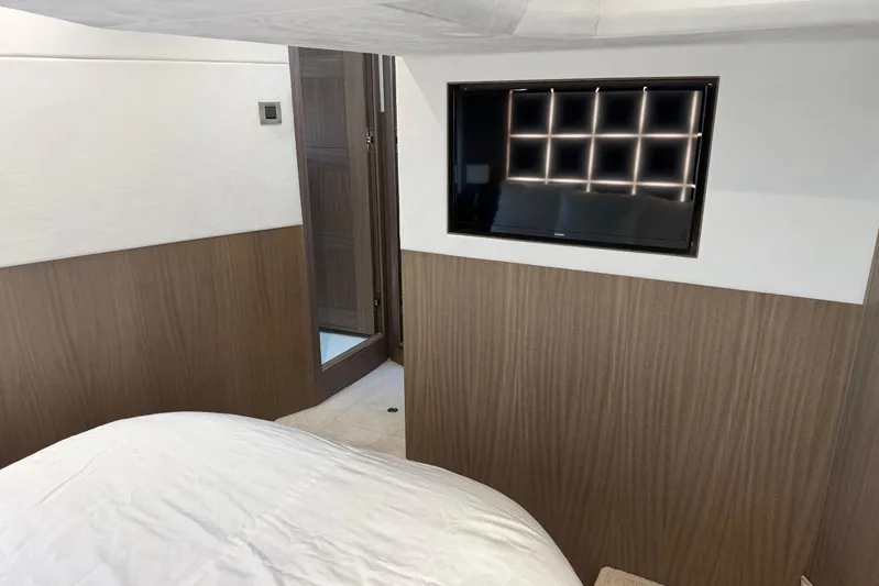  Yacht Photos Pics Interior of 2019 Galeon 470 Sky yacht with modern wood paneling and wall-mounted TV.