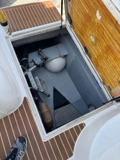 Bobcat Yacht Photos Pics Open hatch on 2010 Cruiser Cats Havana 38, revealing storage compartment and equipment.