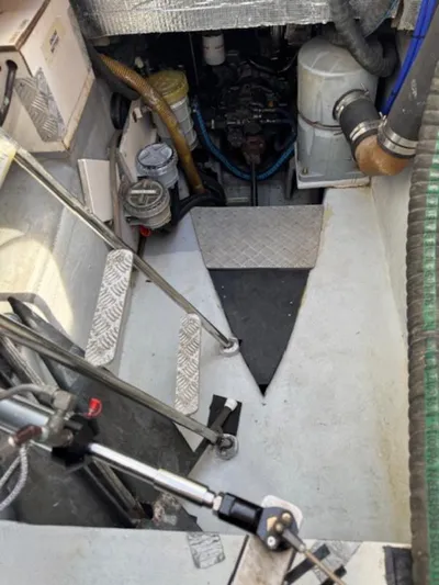 Bobcat Yacht Photos Pics Engine compartment of a 2010 Cruiser Cats Havana 38 catamaran, showing mechanical components and access steps.