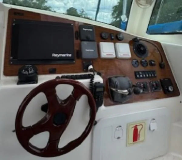 Bobcat Yacht Photos Pics Control panel of a 2010 Cruiser Cats Havana 38 boat with steering wheel and navigation equipment.