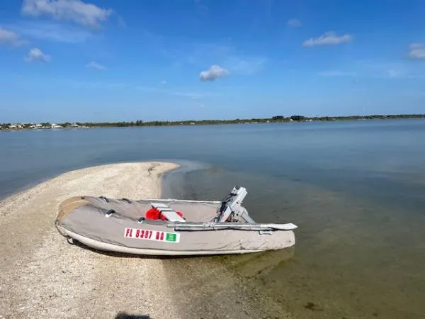 Bobcat Yacht Photos Pics Inflatable boat on sandy shore under clear blue sky, Cruiser Cats Havana 38, 2010 model.