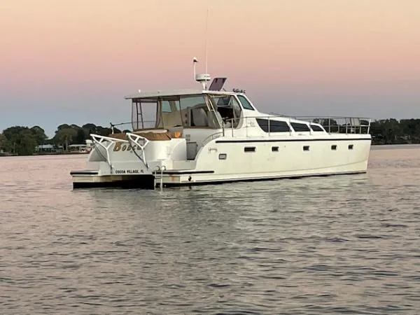 Bobcat Yacht Photos Pics 2010 Cruiser Cats Havana 38 yacht on calm water at sunset.