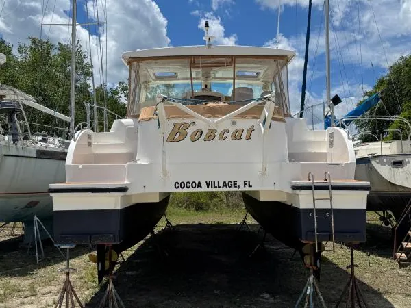 Bobcat Yacht Photos Pics Cruiser Cats Havana 38 catamaran, named "Bobcat," docked in Cocoa Village, FL, under a blue sky.