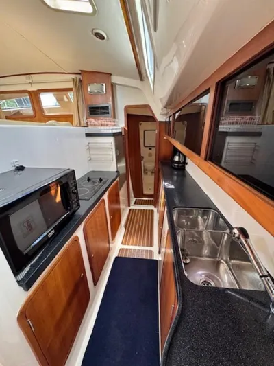 Bobcat Yacht Photos Pics 2010 Cruiser Cats Havana 38 yacht kitchen with modern appliances and wood cabinetry.