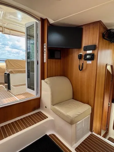 Bobcat Yacht Photos Pics Interior of 2010 Cruiser Cats Havana 38, featuring seating, wood paneling, and marine electronics.