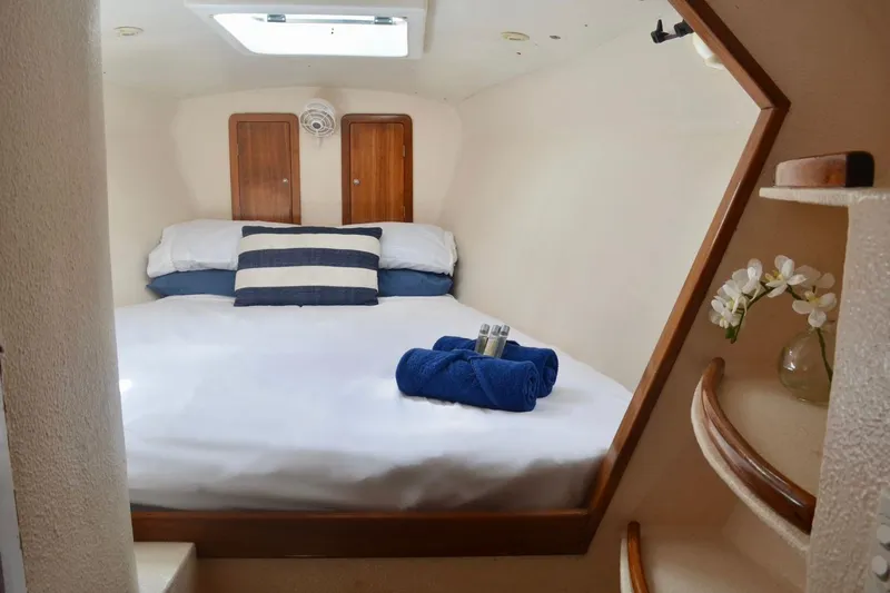 Chef De Mere Yacht Photos Pics Cozy cabin interior of 2006 Royal Cape Catamarans 50 with bed and decorative elements.