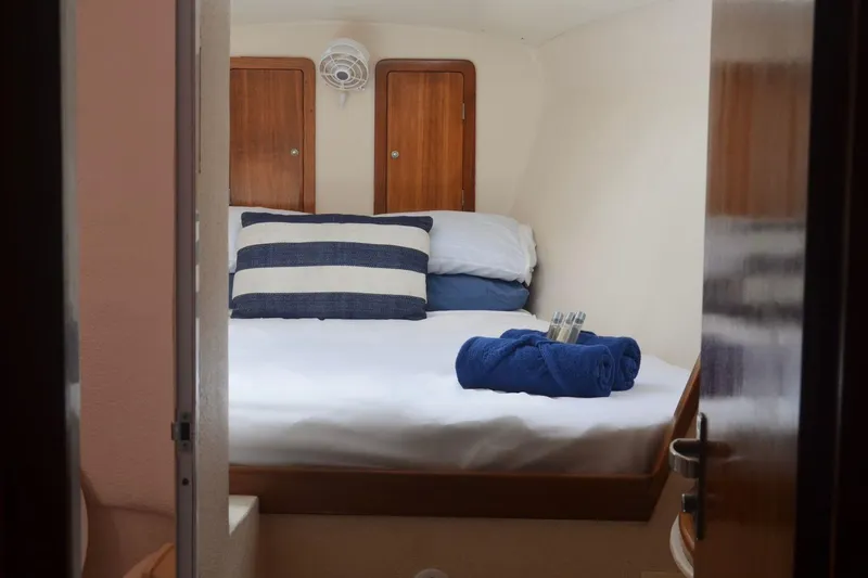 Chef De Mere Yacht Photos Pics Cozy cabin interior of 2006 Royal Cape Catamarans 50 with neatly arranged bedding.
