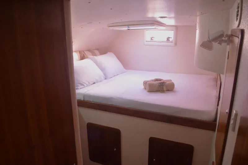 Chef De Mere Yacht Photos Pics Cozy cabin interior of 2006 Royal Cape Catamarans 50 with neatly arranged bed.