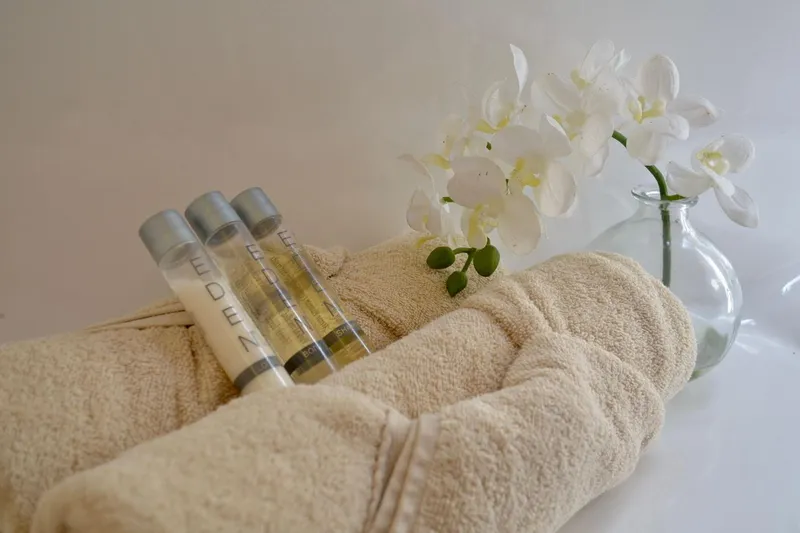 Chef De Mere Yacht Photos Pics Luxurious spa setup with towels, toiletries, and white orchids in a vase.