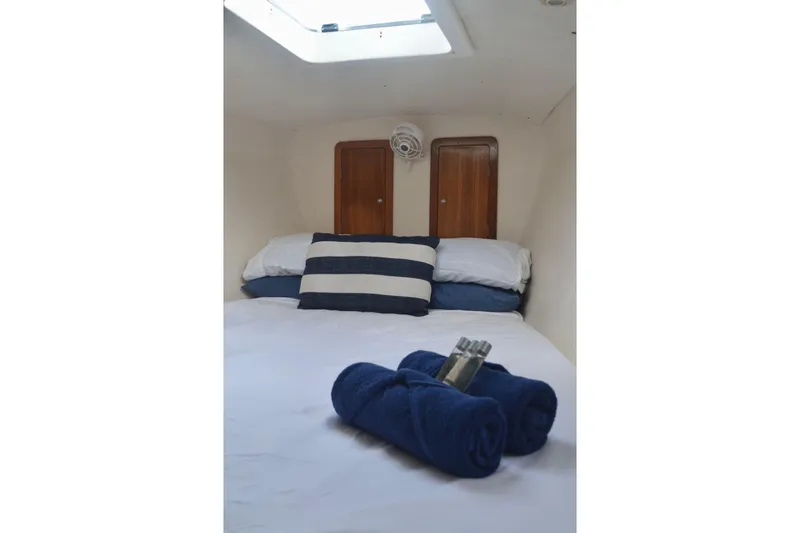 Chef De Mere Yacht Photos Pics Cozy cabin interior of 2006 Royal Cape Catamarans 50 with striped pillow and rolled towels.