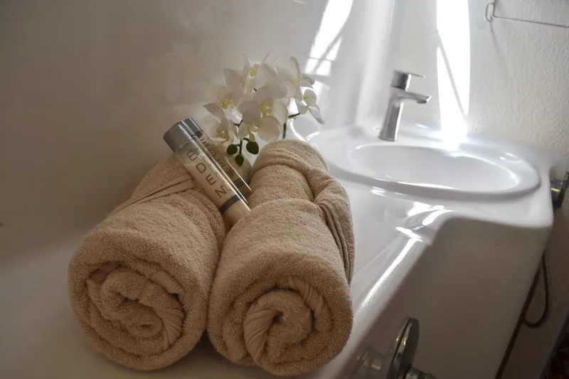 Chef De Mere Yacht Photos Pics Luxurious bathroom setup on 2006 Royal Cape Catamarans 50, featuring towels and toiletries.