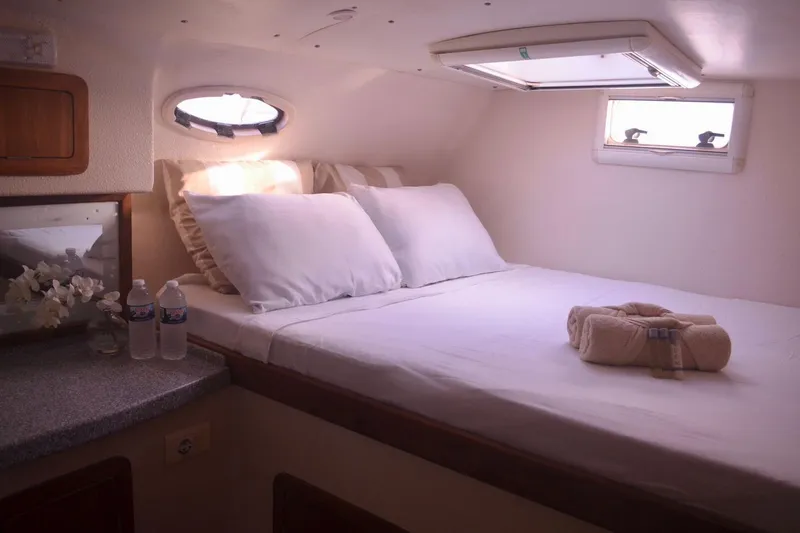 Chef De Mere Yacht Photos Pics Luxurious cabin interior of 2006 Royal Cape Catamarans 50 with cozy bed and natural light.