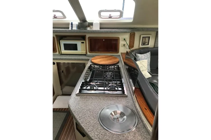 Chef De Mere Yacht Photos Pics Interior of 2006 Royal Cape Catamarans 50, featuring a modern kitchen with stove and microwave.