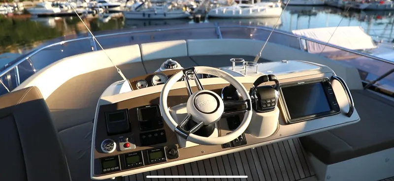  Yacht Photos Pics Helm of 2013 Prestige 620 yacht with modern controls and marina view.