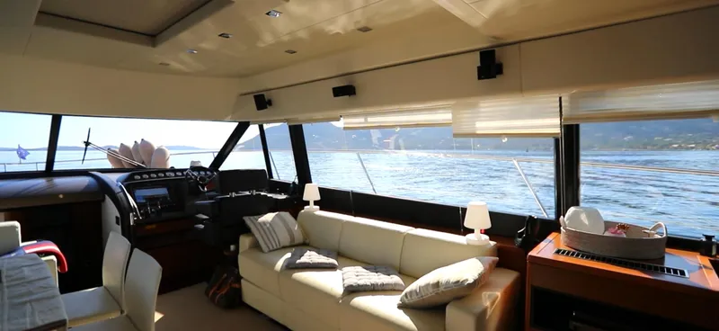  Yacht Photos Pics Luxurious interior of a 2013 Prestige 620 yacht with panoramic windows and elegant furnishings.