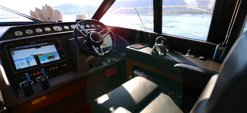  Yacht Photos Pics Cockpit of 2013 Prestige 620 yacht with navigation controls and scenic ocean view.