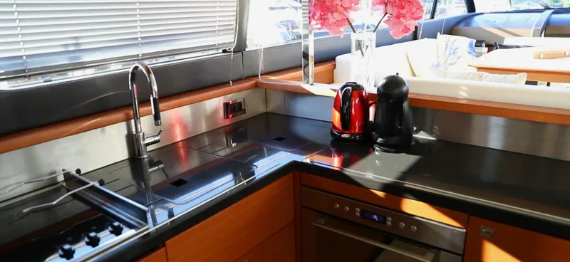  Yacht Photos Pics Modern kitchen in a 2013 Prestige 620 yacht with sleek countertops and appliances.