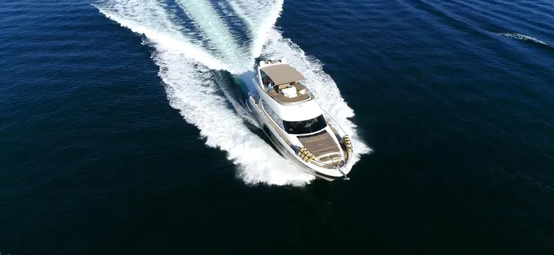  Yacht Photos Pics Prestige 620 yacht cruising on open water, aerial view, 2013 model.