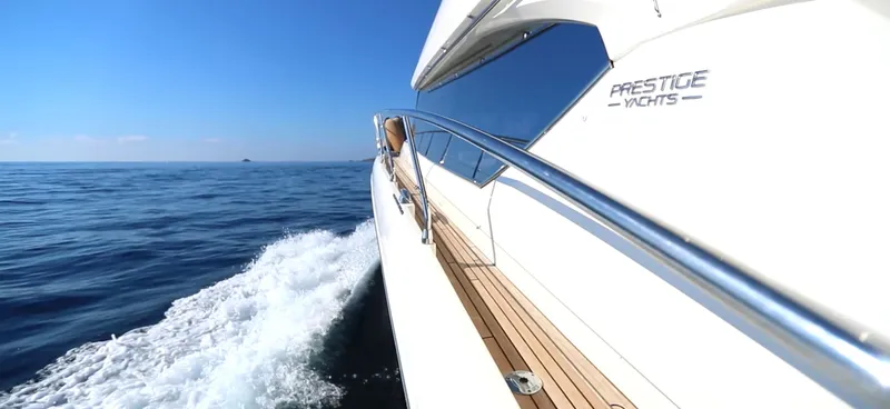  Yacht Photos Pics 2013 Prestige 620 yacht cruising on open sea under clear blue sky.
