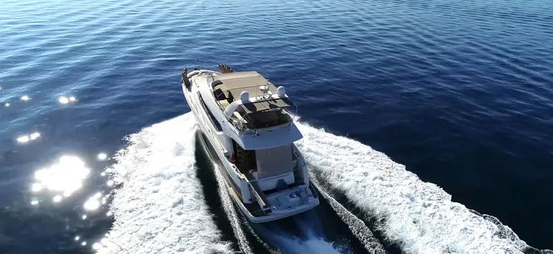  Yacht Photos Pics Prestige 620 yacht cruising on open water, 2013 model, aerial view.