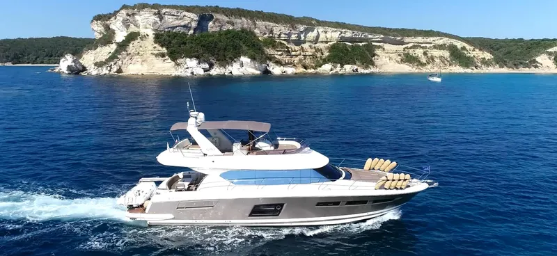  Yacht Photos Pics Luxury Prestige 620 yacht cruising near scenic cliffs, 2013 model.