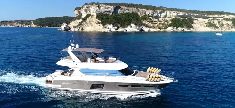  Yacht Photos Pics Luxurious 2013 Prestige 620 yacht cruising near scenic coastal cliffs.